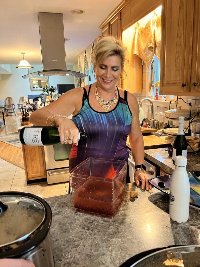 Woman pouring a blended drink into a container in a kitchen.