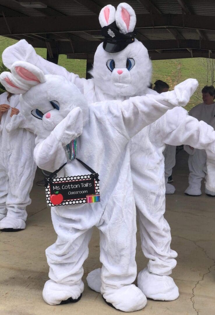 Two people in bunny costumes dabbing.