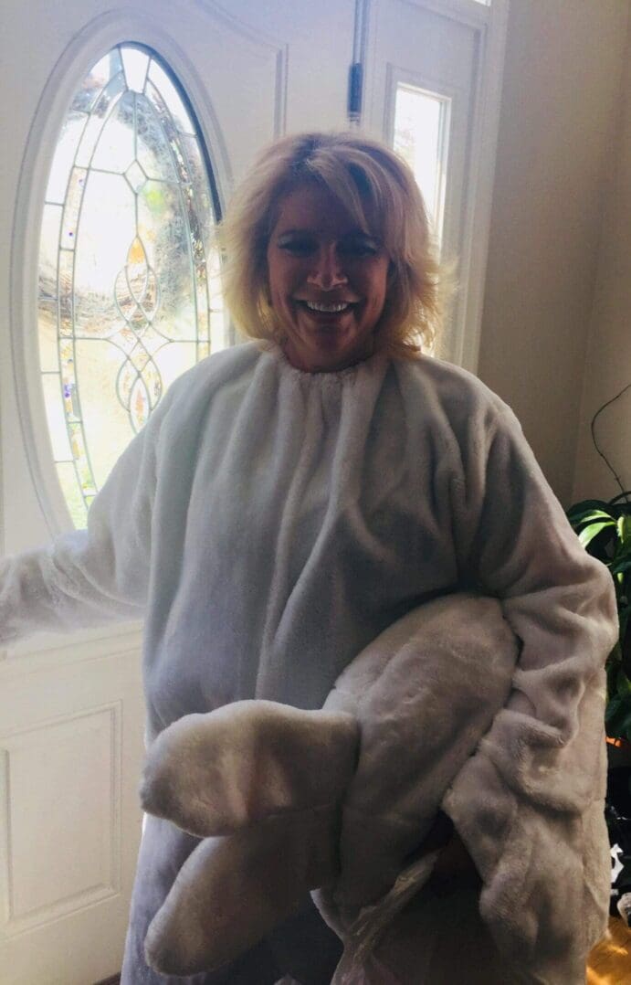 Person wearing fluffy costume near door.