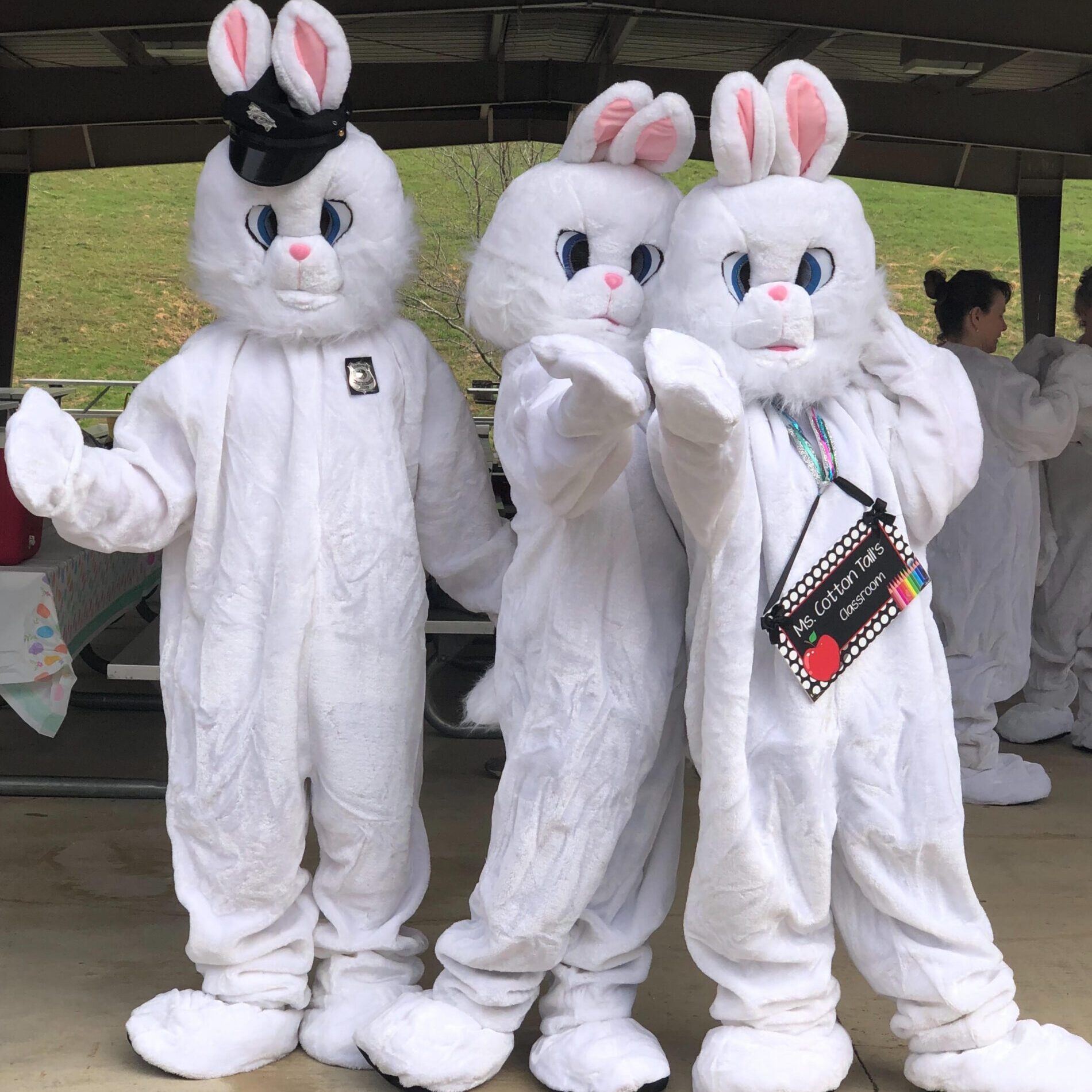 Three people in white bunny costumes.